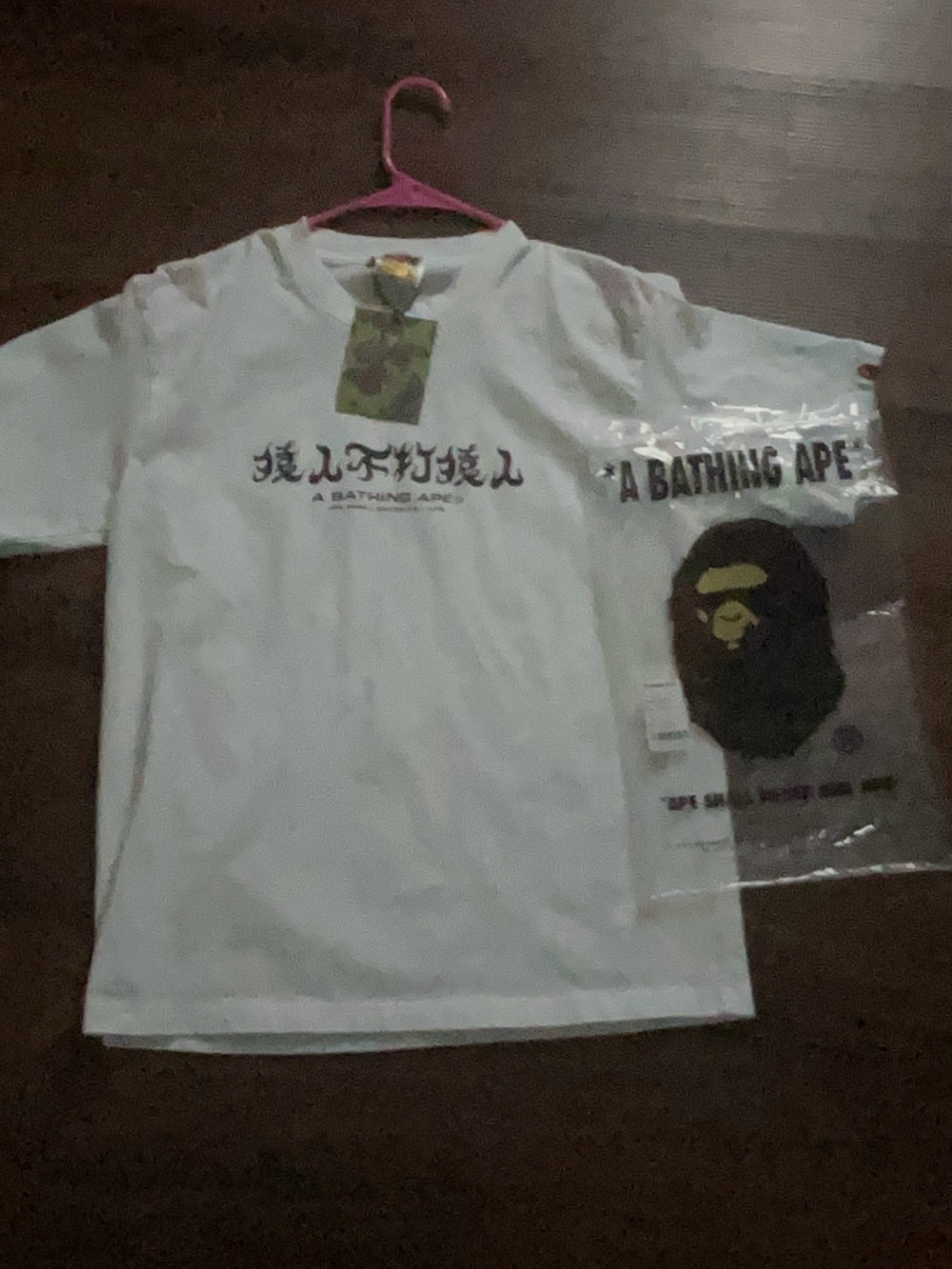Bape kanji tee shirt with kanji text in the front with a bathing ape in the back